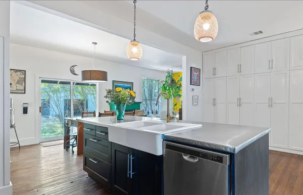 a kitchen with a table chairs and wooden floor