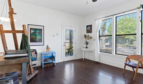 a view of front door with hallway and wooden floor