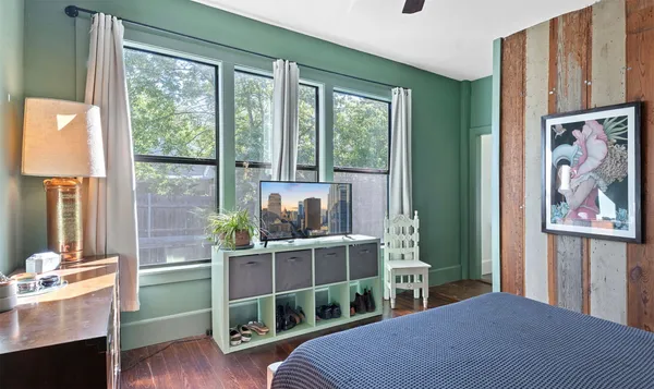a bedroom with a bed and a dresser in it