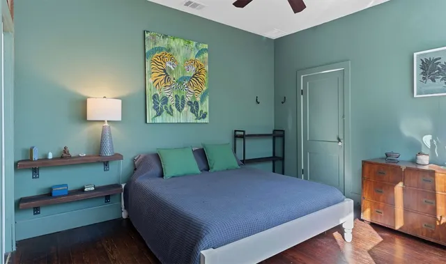 a bedroom with a bed and a dresser in it