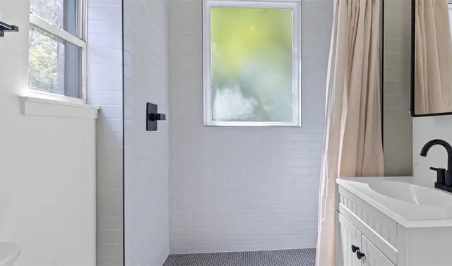 a bathroom with a sink and a window