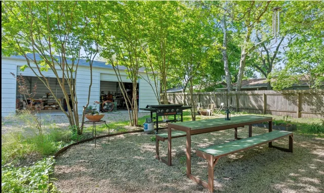 a view of a bench in the garden near a lake
