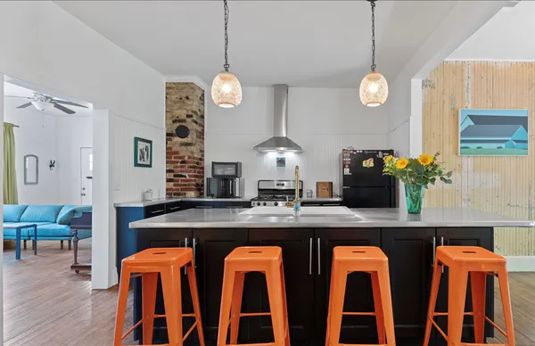a large kitchen with a table and chairs in it