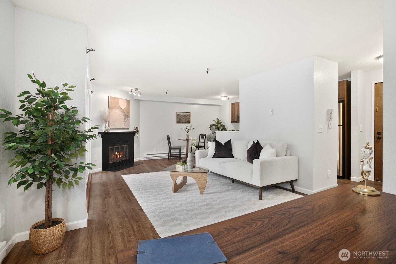 1100 Harrington Avenue Northeast, Unit 211 Renton, WA 98056 - Photo 1 of 20 a living room with furniture and a fireplace
