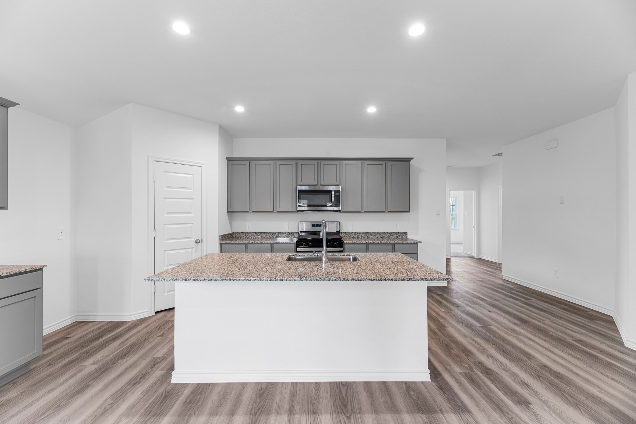 5680 Spoonbill Orange, TX 77632 - Photo 3 of 23 a large kitchen with stainless steel appliances granite countertop a stove a sink and a refrigerator