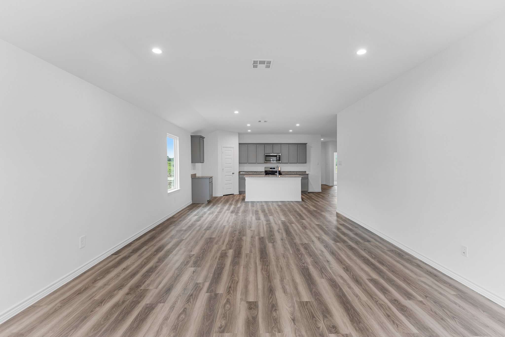 5680 Spoonbill Orange, TX 77632 - Photo 6 of 23 a view of a kitchen with wooden floor a sink and a window