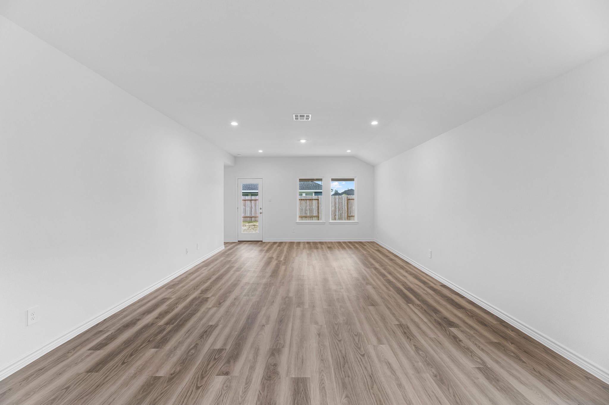 5680 Spoonbill Orange, TX 77632 - Photo 7 of 23 a view of an empty room with wooden floor and a window