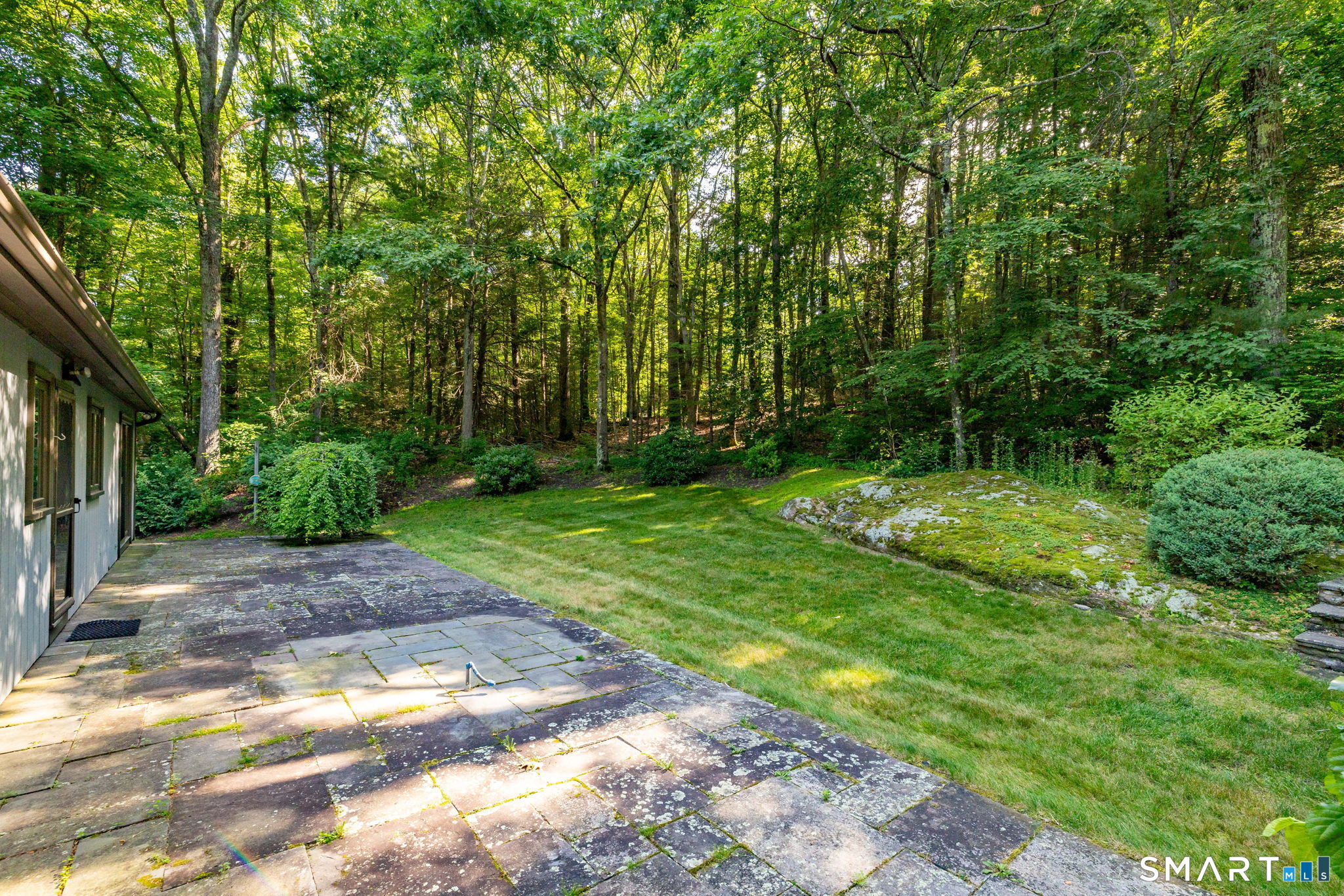 274 Steele Road New Hartford, CT 06057 - Photo 23 of 39 Oversized slate patio overlooking the private backyard