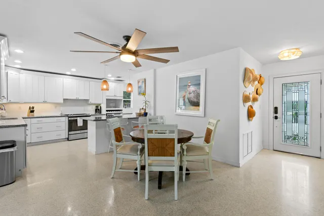 a dining room with furniture a window and kitchen view