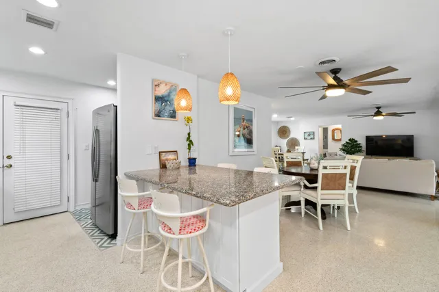 a kitchen with granite countertop a sink and a stove