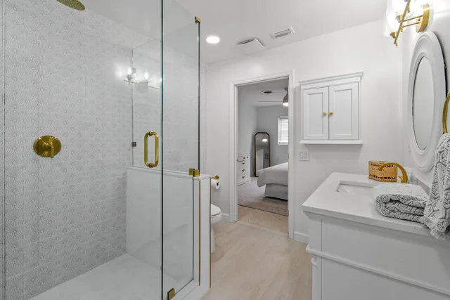 a spacious bedroom with a large bed and a flat tv screen