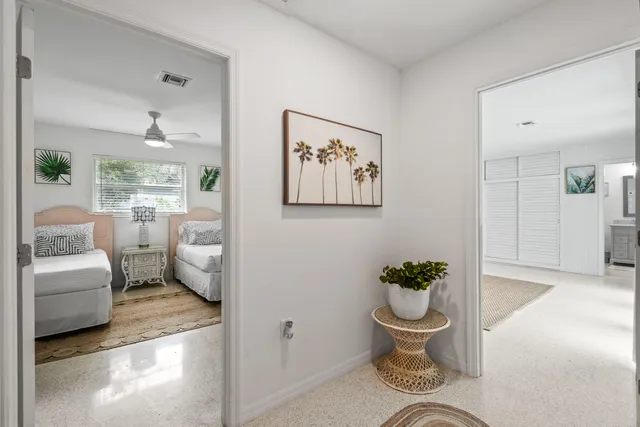 a bathroom with a toilet a sink a glass door a shower a mirror a vanity and window