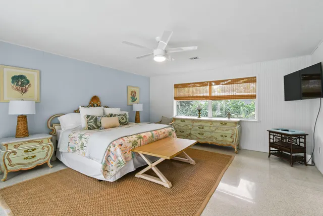 an outdoor sitting area with chairs and umbrella