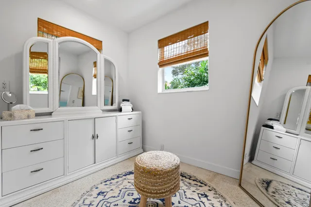 a view of a patio with couches table and chairs and potted plants