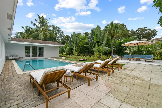 a view of swimming pool with outdoor seating and a yard