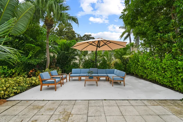 a view of a fountain in front of a house with a big yard