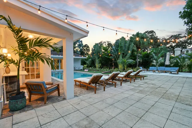a view of a patio with table and chairs and potted plants