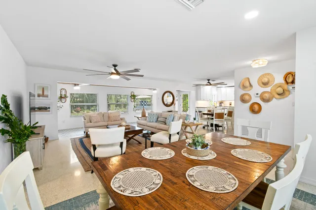 a dining room with furniture a rug and wooden floor