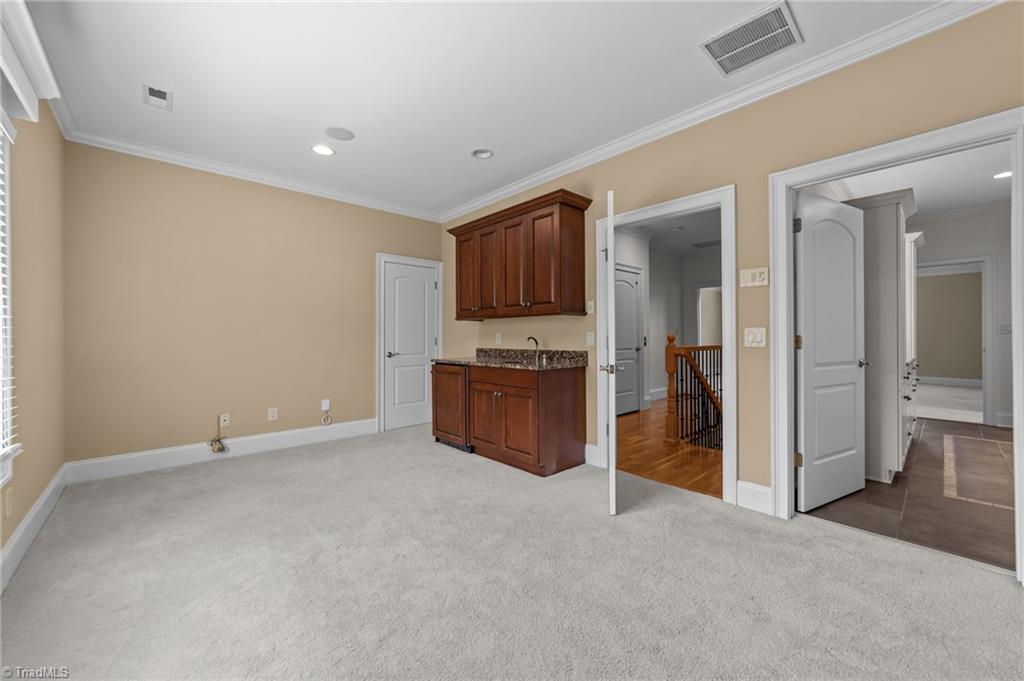7911 Quiet Place Oak Ridge, NC 27310 - Photo 25 of 46 3rd level mini fridge! wet bar/2 storage rooms. Many uses!