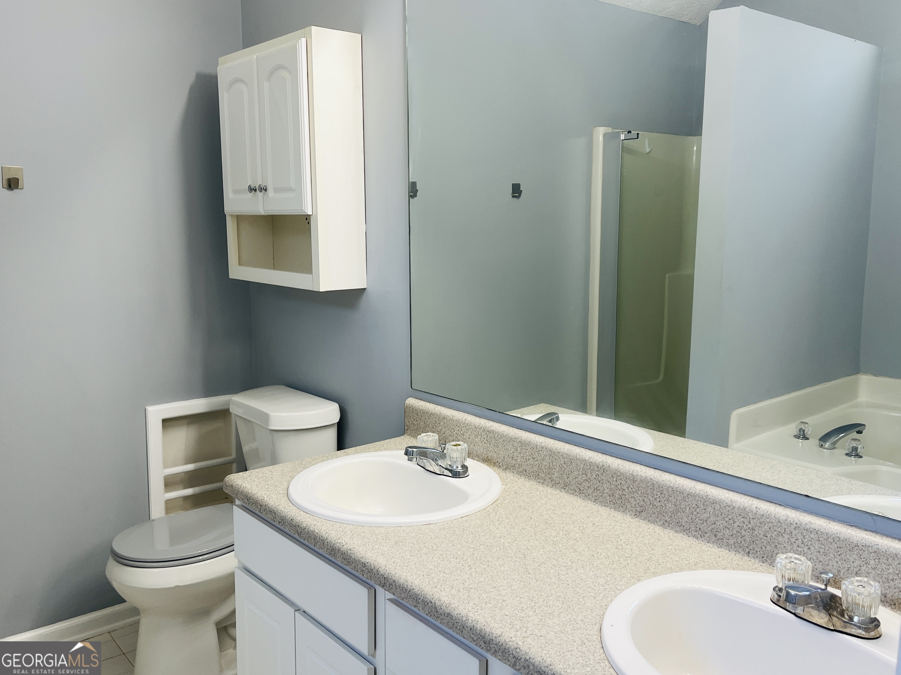 405 Peeks Crossing Drive Senoia, GA 30276 - Photo 24 of 31 a bathroom with a sink and a mirror