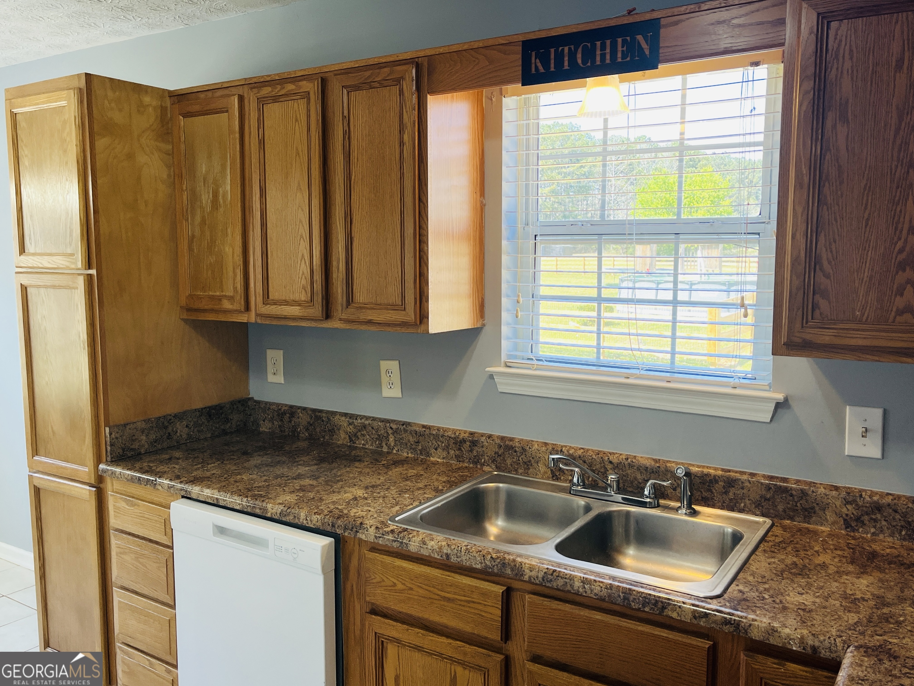 405 Peeks Crossing Drive Senoia, GA 30276 - Photo 9 of 31 a kitchen with granite countertop a sink and a window