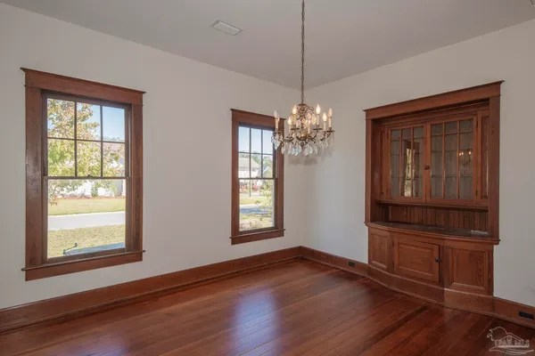 a view of a room with window wooden floor and chandelier