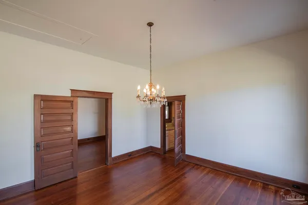 a view of a room with wooden floor and cabinet