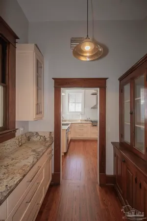 a kitchen with granite countertop white cabinets and white appliances