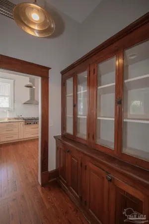 a kitchen with stainless steel appliances granite countertop a sink a stove and a window with wooden floor