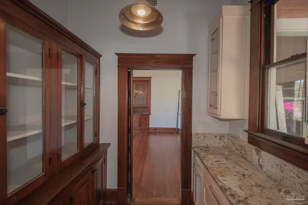 a kitchen with stainless steel appliances a sink cabinets and a window