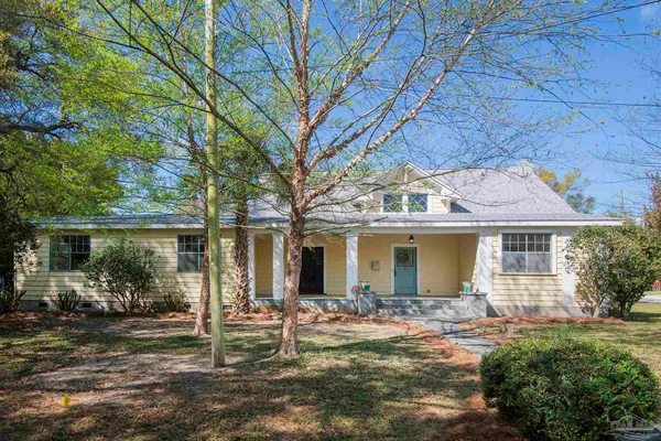 front view of house with a tree in front of it