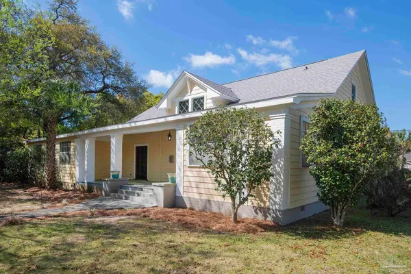 a view of a house with yard and tree s