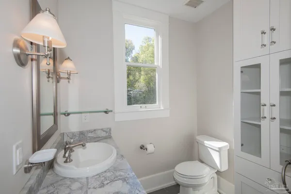 a view of an empty room with closet and a window