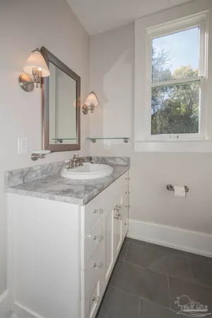 an empty room with wooden floor closet and windows