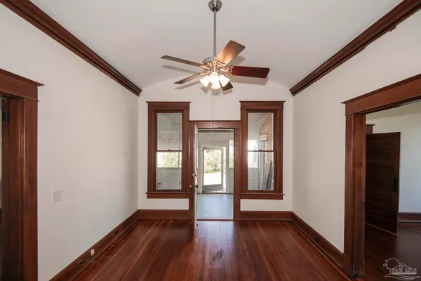 a view of empty room with wooden floor