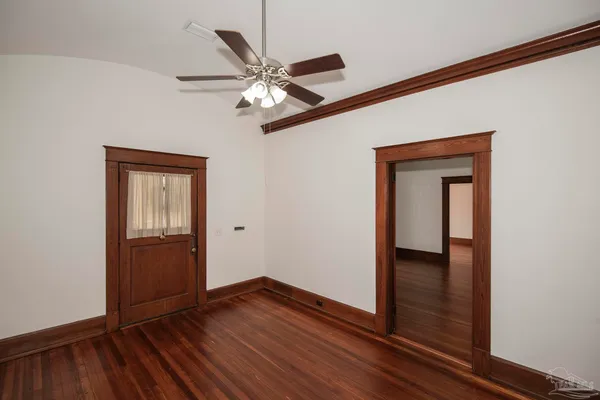 a view of empty room with wooden floor