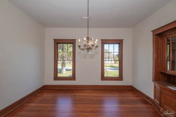 a view of a windows and chandelier in a room with wooden floor