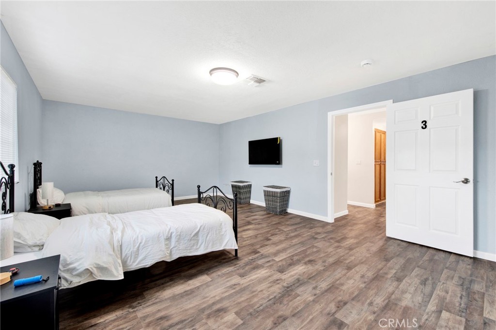31511 Indian Oak Road Acton, CA 93510 - Photo 17 of 32 a bedroom with a bed and a flat screen tv