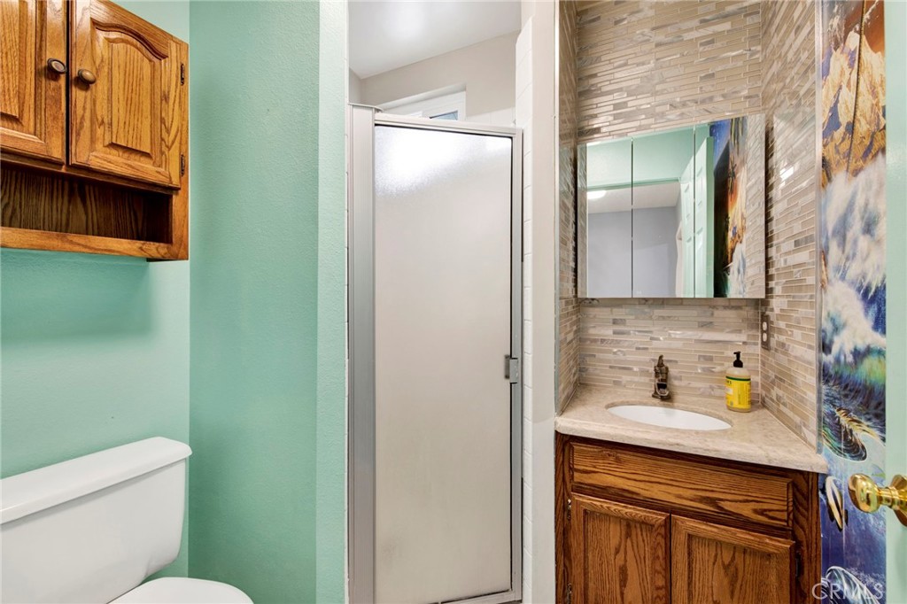 31511 Indian Oak Road Acton, CA 93510 - Photo 20 of 32 a bathroom with a sink a toilet and shower curtain