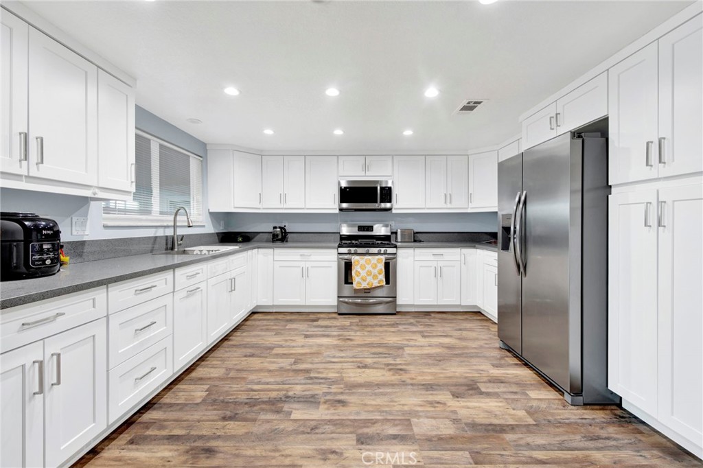 31511 Indian Oak Road Acton, CA 93510 - Photo 6 of 32 a kitchen with granite countertop a refrigerator and a stove top oven