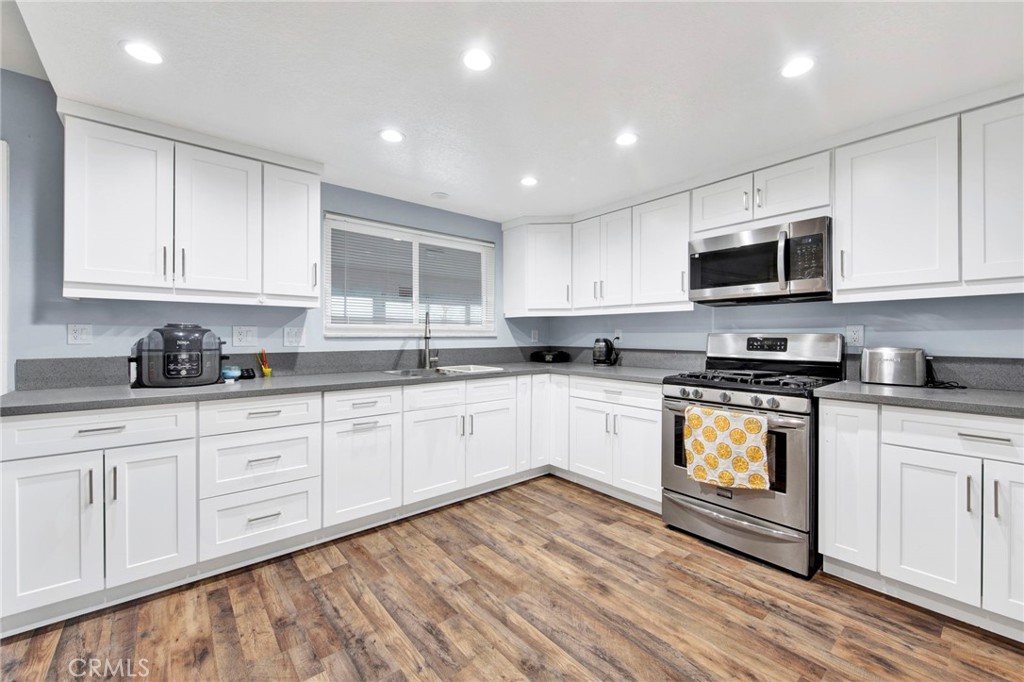 31511 Indian Oak Road Acton, CA 93510 - Photo 7 of 32 a kitchen with granite countertop white cabinets sink and stainless steel appliances