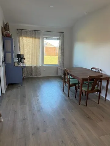 a view of a dining room with furniture and a window