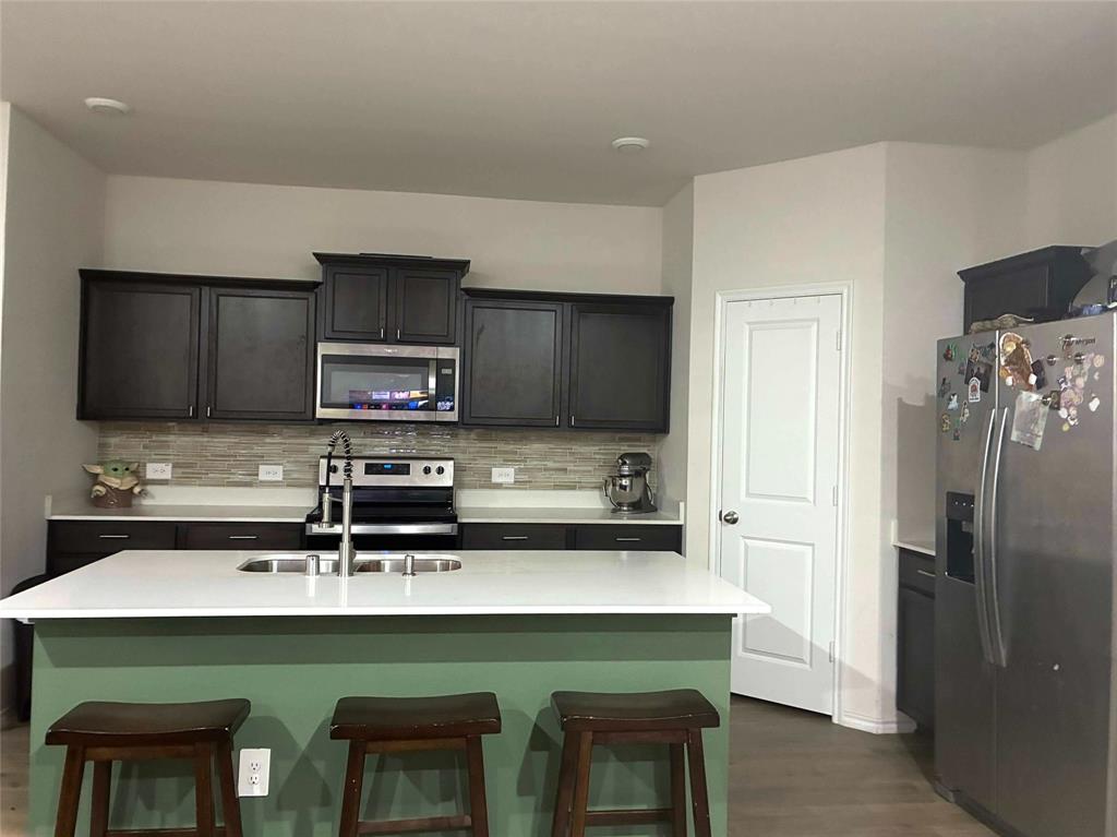 703 Wind Cv Lane Princeton, TX 75407 - Photo 3 of 4 a kitchen with stainless steel appliances a sink and microwave