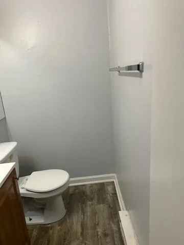 a white toilet sitting next to a shower