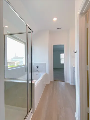 a bathroom with a bathtub and a sink