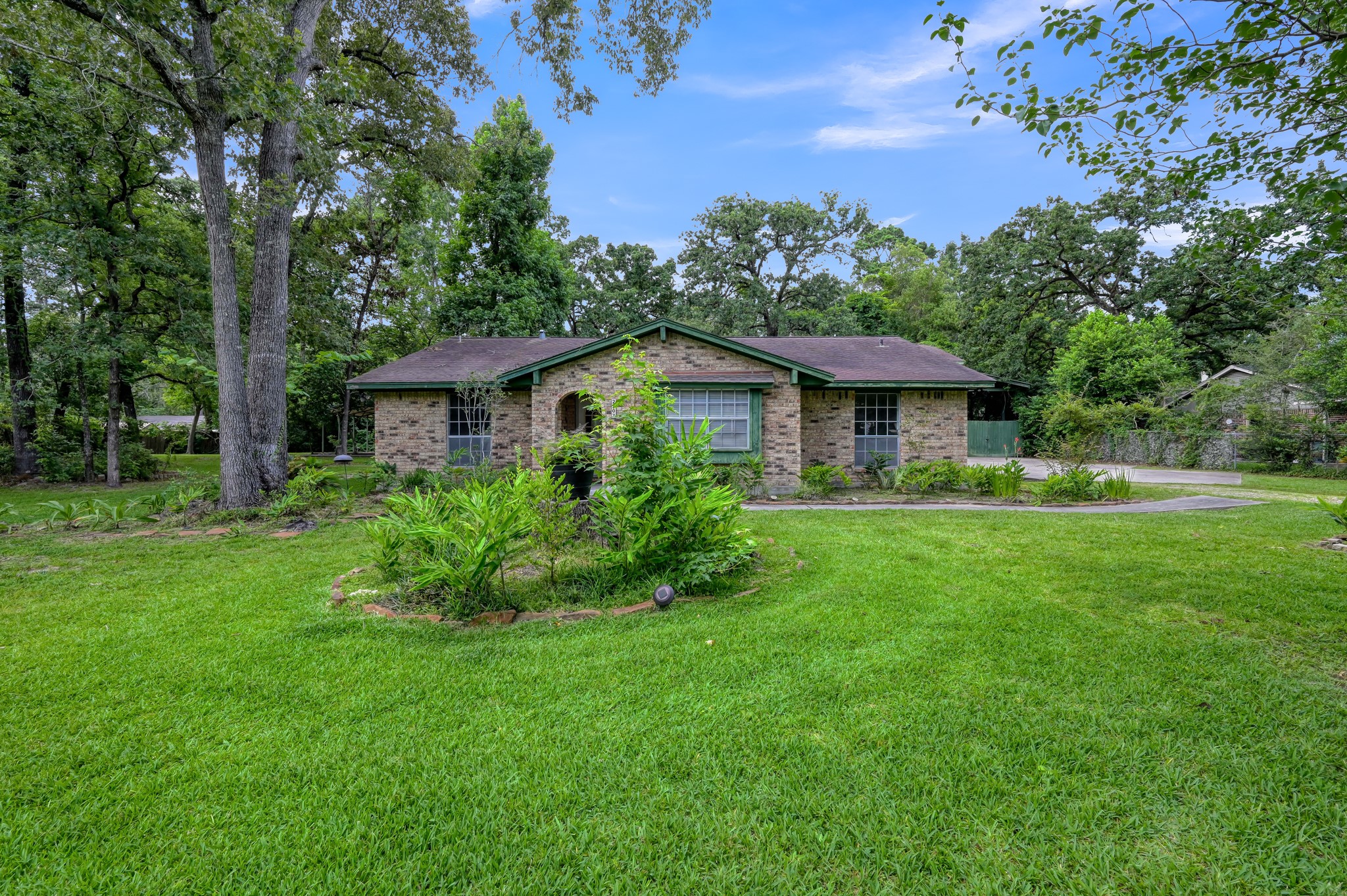 2207 Arendale Lane Spring, TX 77386 - Photo 13 of 30 View of the front of the home showcasing mature landscaping.