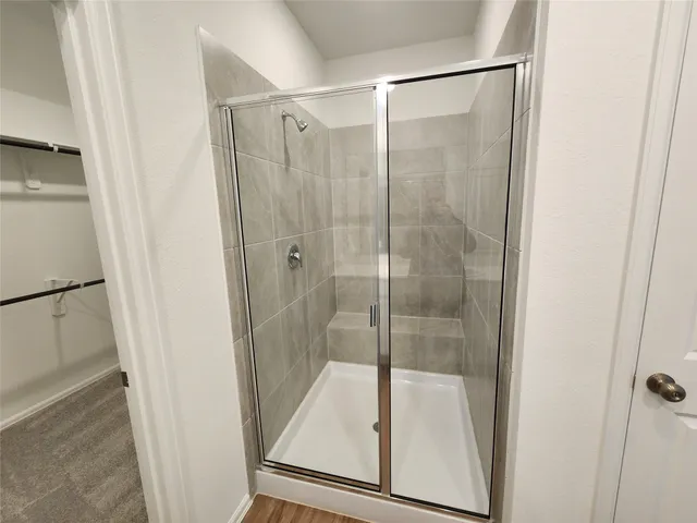 a bathroom with a glass shower door