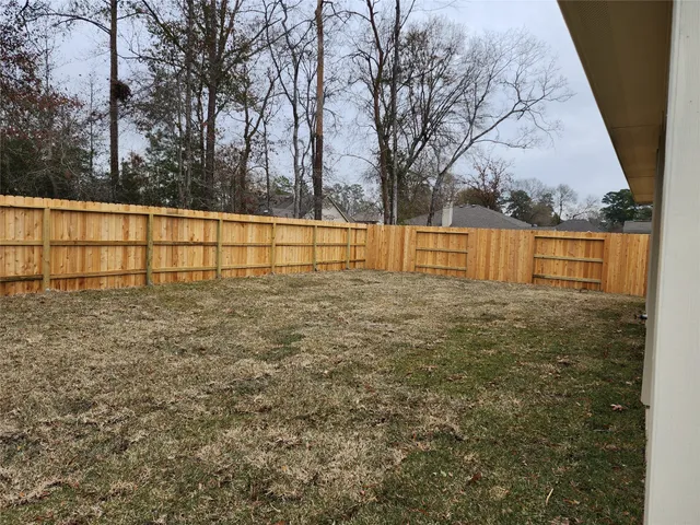 a view of swimming pool with trees in front of it