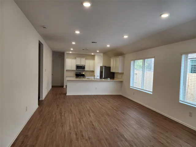 a view of kitchen with wooden floor and window
