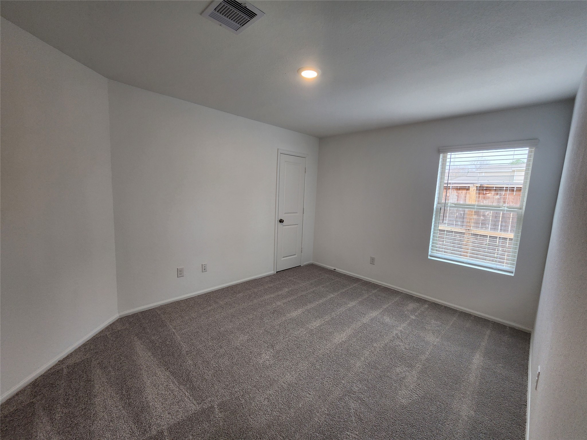 1954 Ballesteros Street Crosby, TX 77532 - Photo 6 of 16 an empty room with a empty space and windows